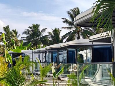 Installed capsule cabins in a tropical resort setting with palm trees