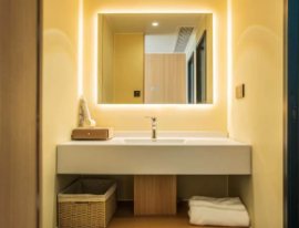 Compact capsule cabin vanity with illuminated mirror and basin